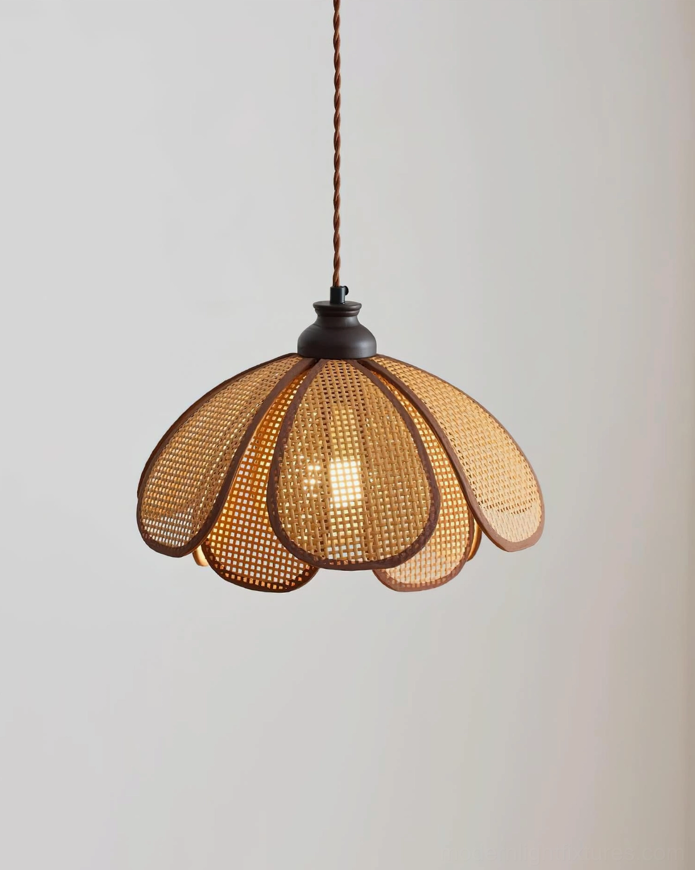 Bottom view of Capelina rattan pendant lamp showing inner woven structure and light diffusion pattern
