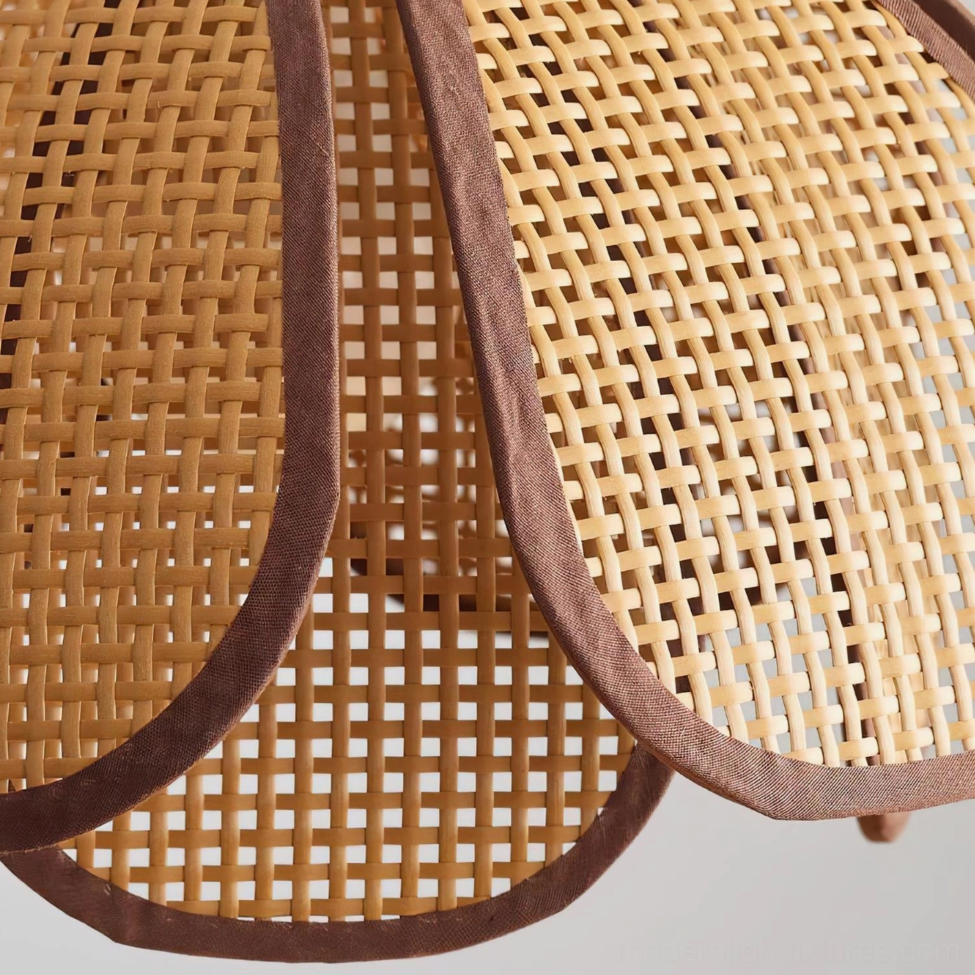 Close-up of Capelina rattan weave pattern and petal-shaped shade construction for modern pendant lighting