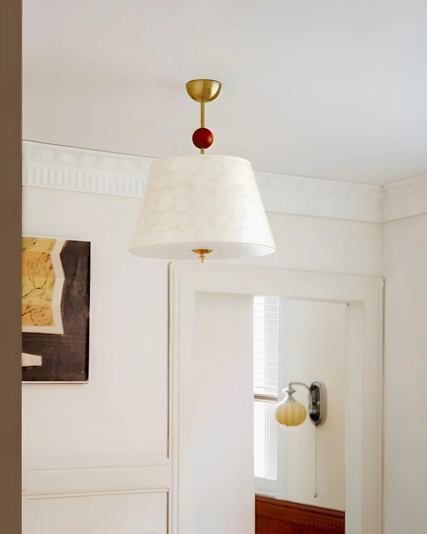 Contemporary ceiling pendant fixture in entryway with small off-white shade, brass and wooden accent hardware detail