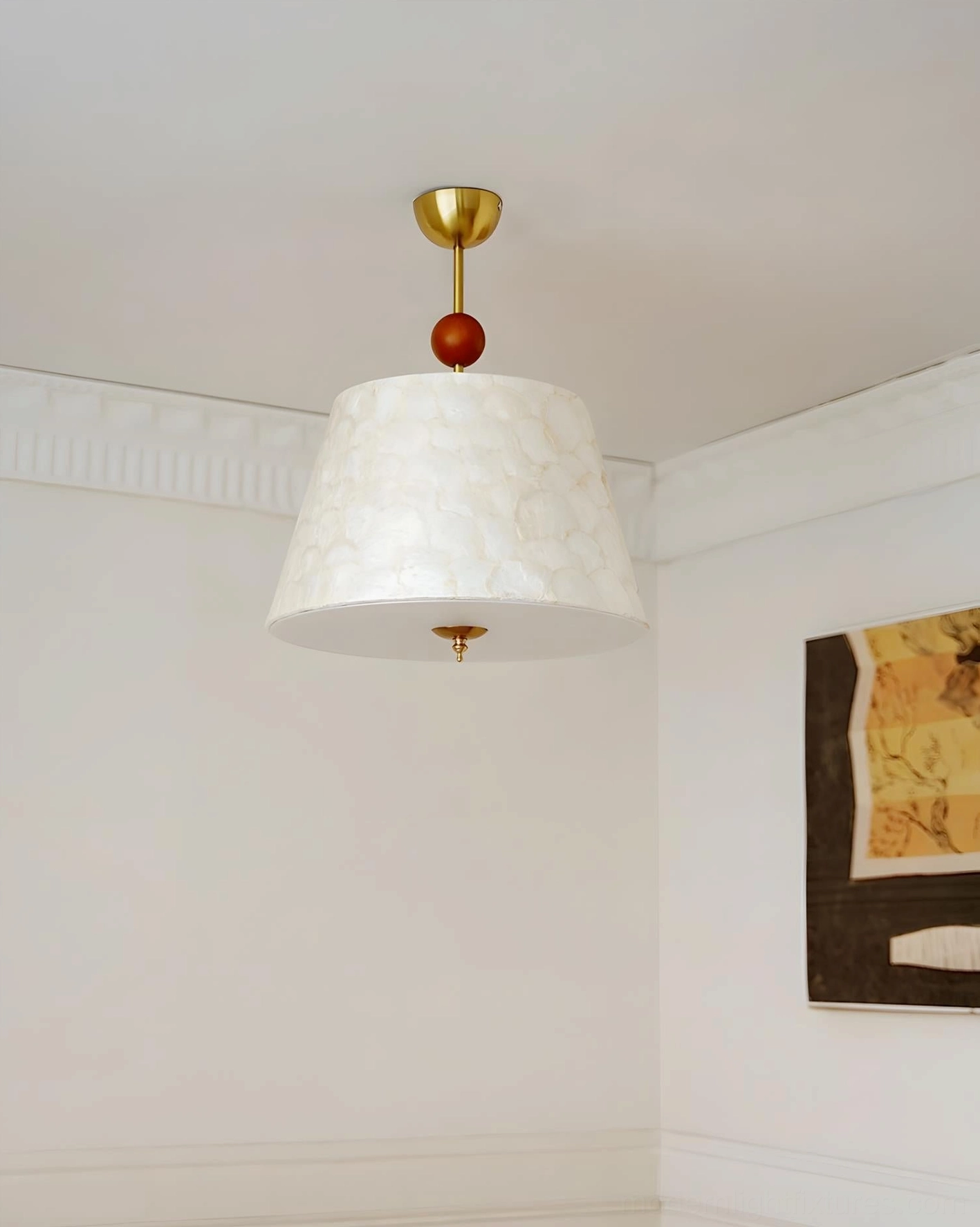 Minimalist tapered ceiling pendant with brass hardware, wooden accent bead, and solid off-white shade in neutral white room