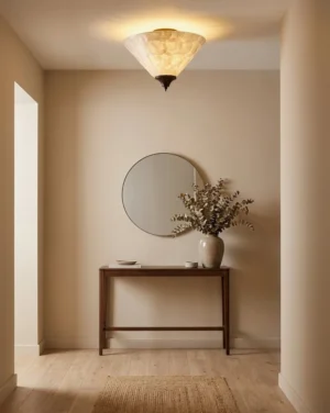 Capelle flush mount light fixture installed in residential hallway, warm pearly glow illuminating entry space with artwork