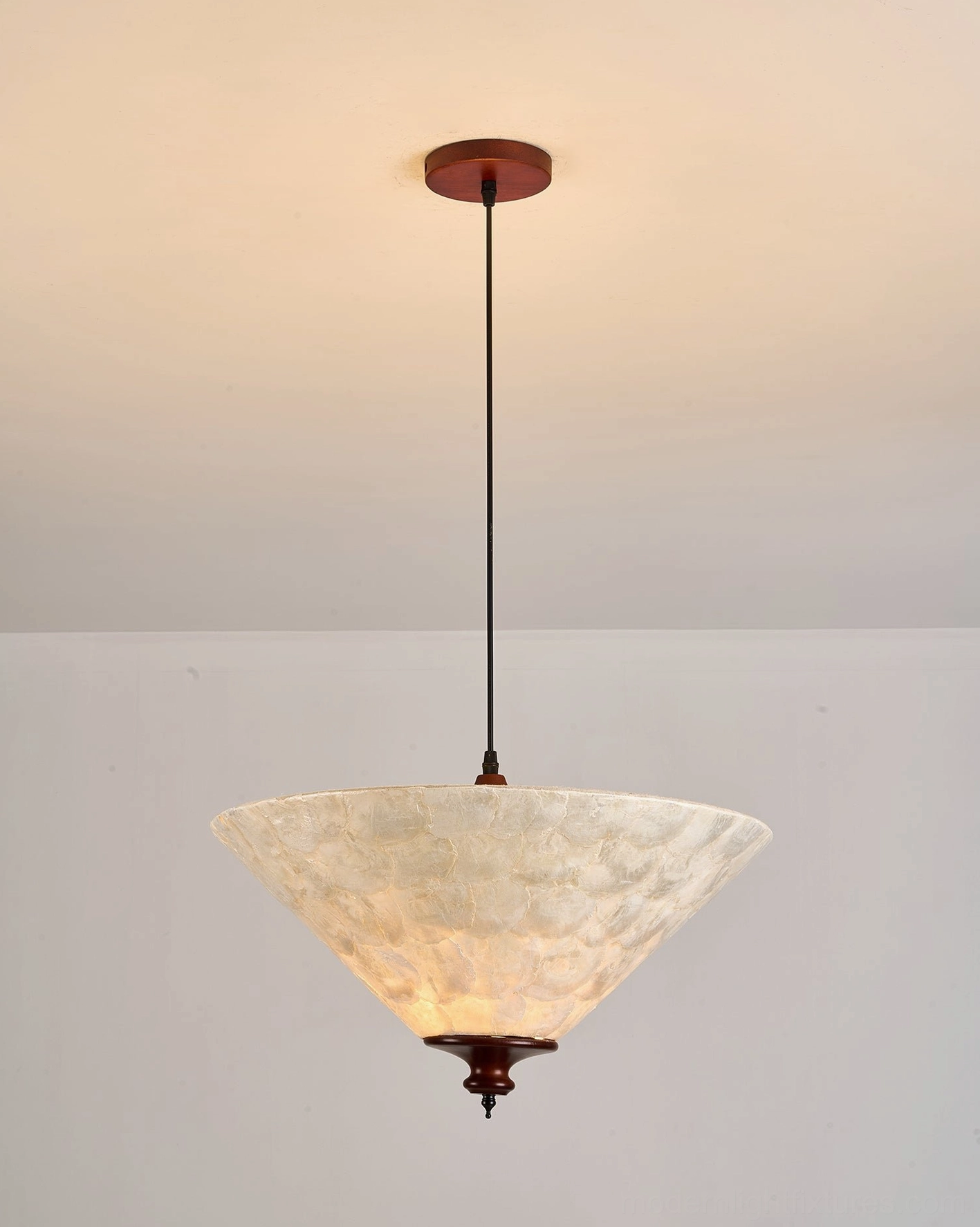 Capelle capiz shell pendant light ceiling-mounted showing warm yellow glowing amber translucent shell and canopy detail