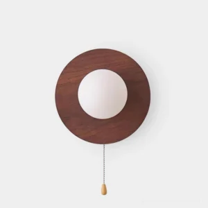 Cara modern wood wall sconce with walnut finish and frosted glass globe, front view studio shot