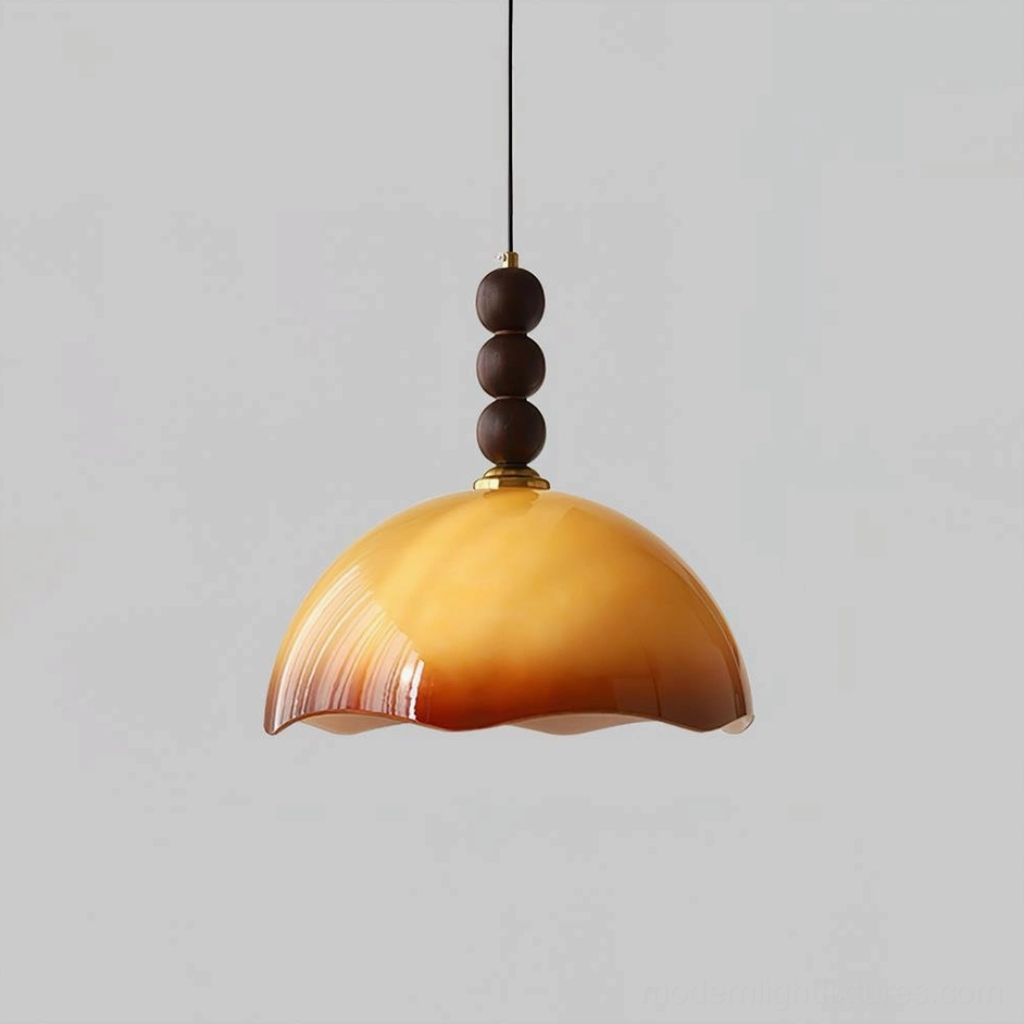 Caramel colored rippled glass pendant light with vertical walnut spheres creating mid-century sculptural form