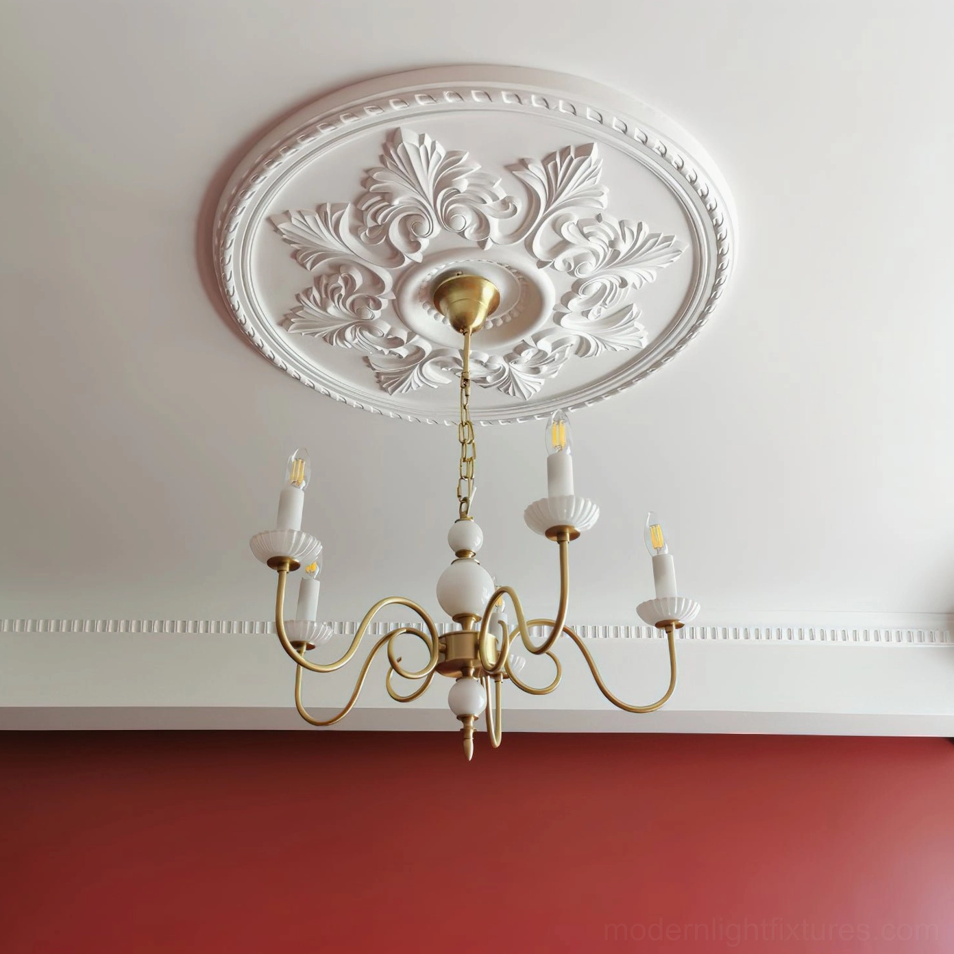 Upward view of installed brass candle chandelier on ornate plaster ceiling medallion