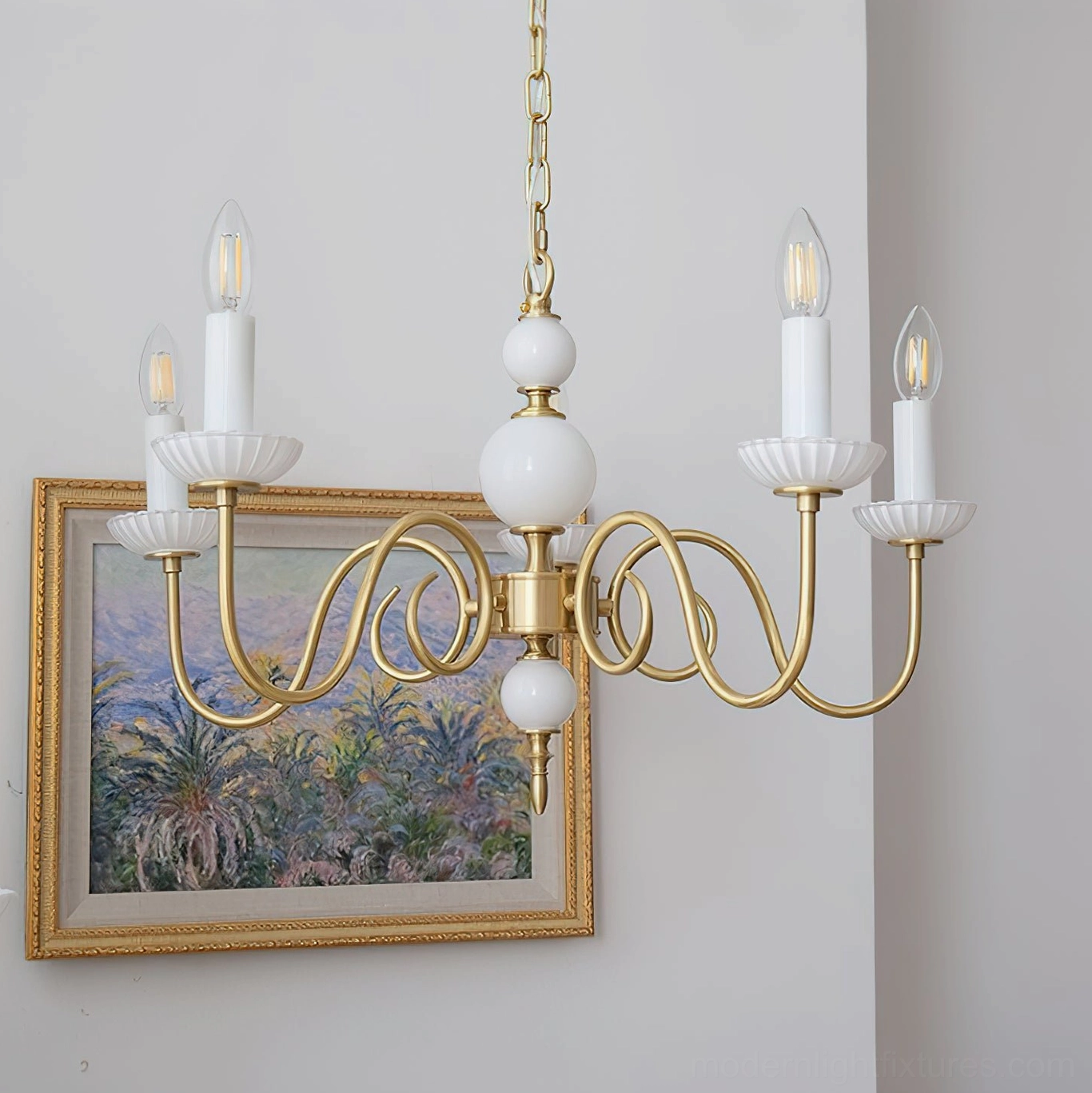 Brass and white candle chandelier installed in residential interior with vintage painting
