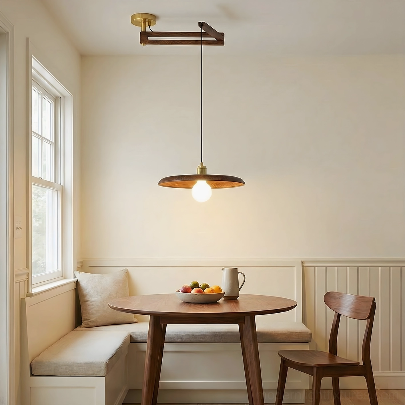 Breakfast nook pendant lamp above window-side dining booth