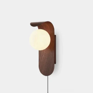 Carlyle plug-in wall sconce with walnut wood-tone finish and frosted glass globe front view