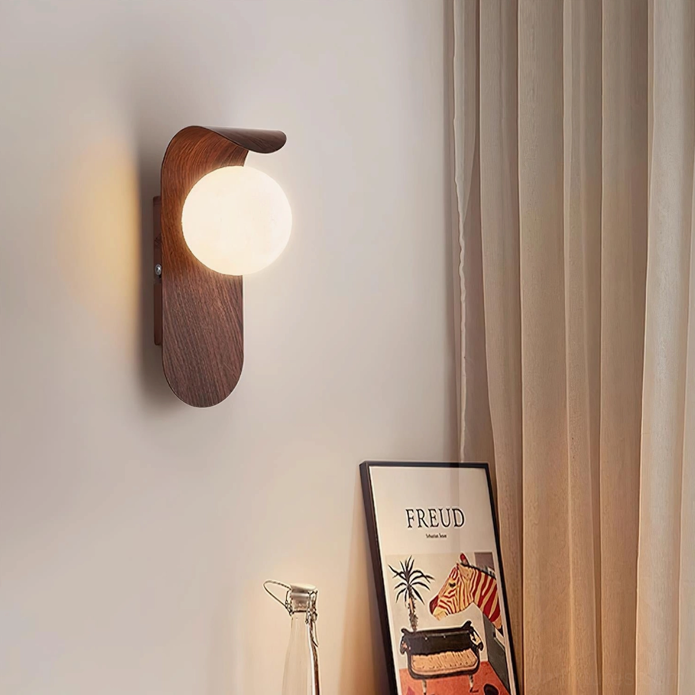Single Carlyle wood-tone wall sconce creating ambient accent light in residential bedroom corner