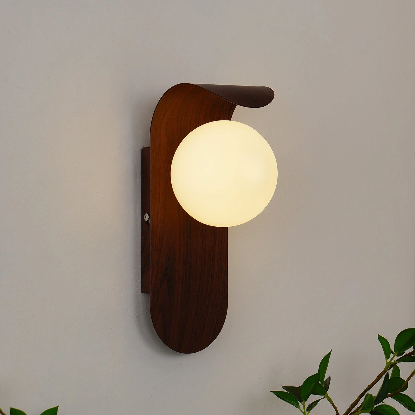 Carlyle wall sconce curved metal arm design positioning frosted glass at optimal angle