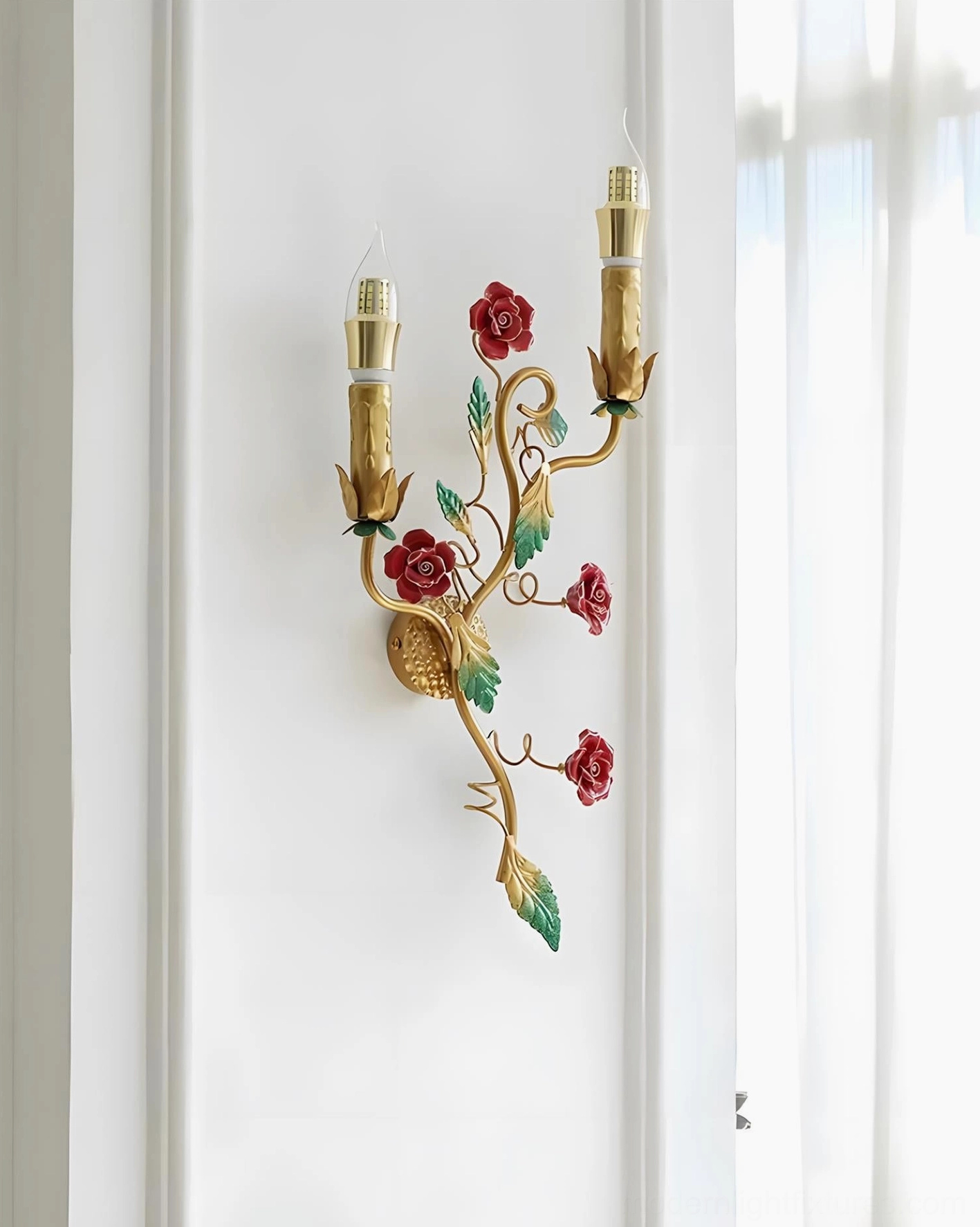 Gold metal Carmelia sconce with hand-painted red and green botanical accents displayed in side view perspective
