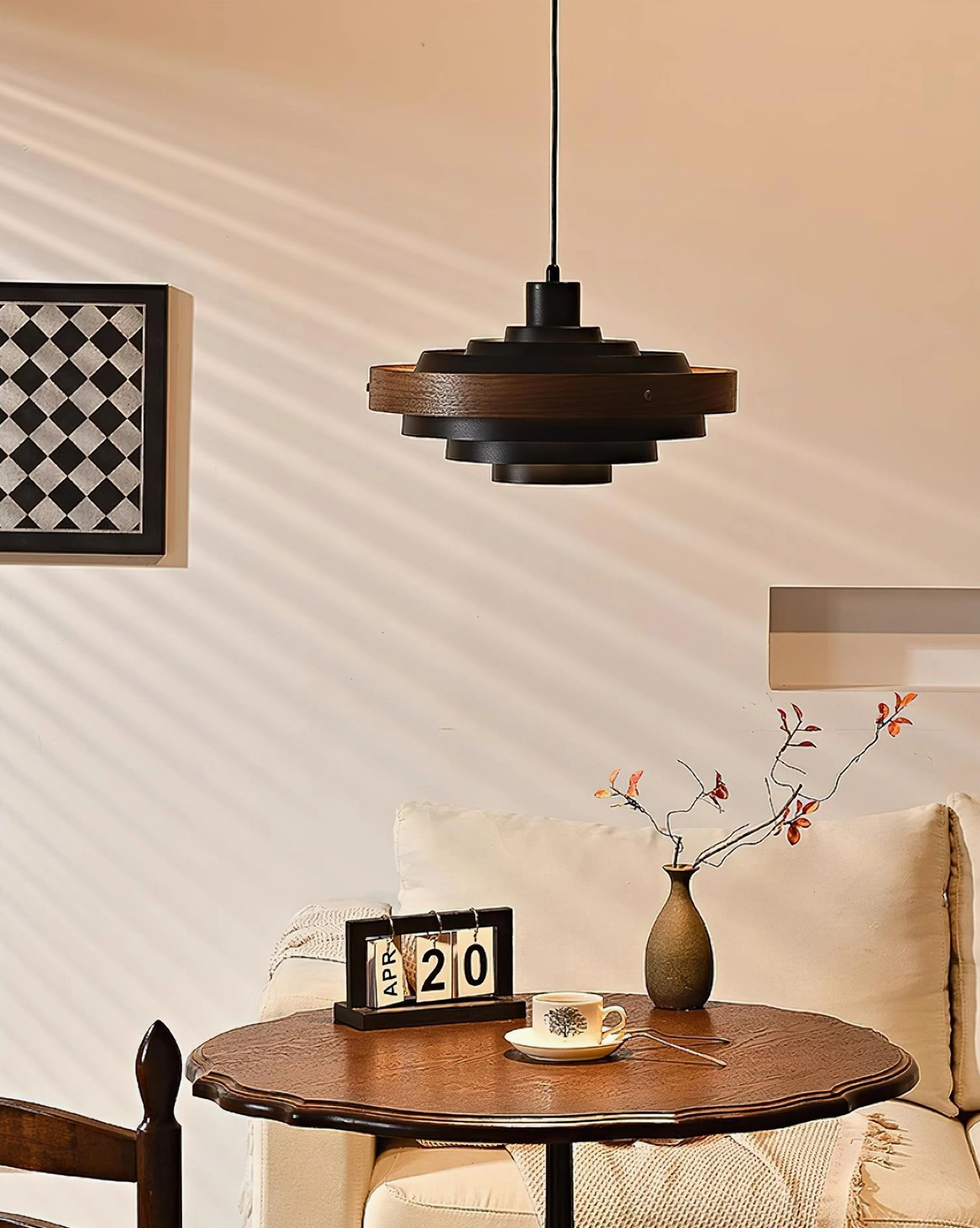 Carmen tiered pendant lamp detail, showing layered metal and wood bands construction and warm interior light diffusion