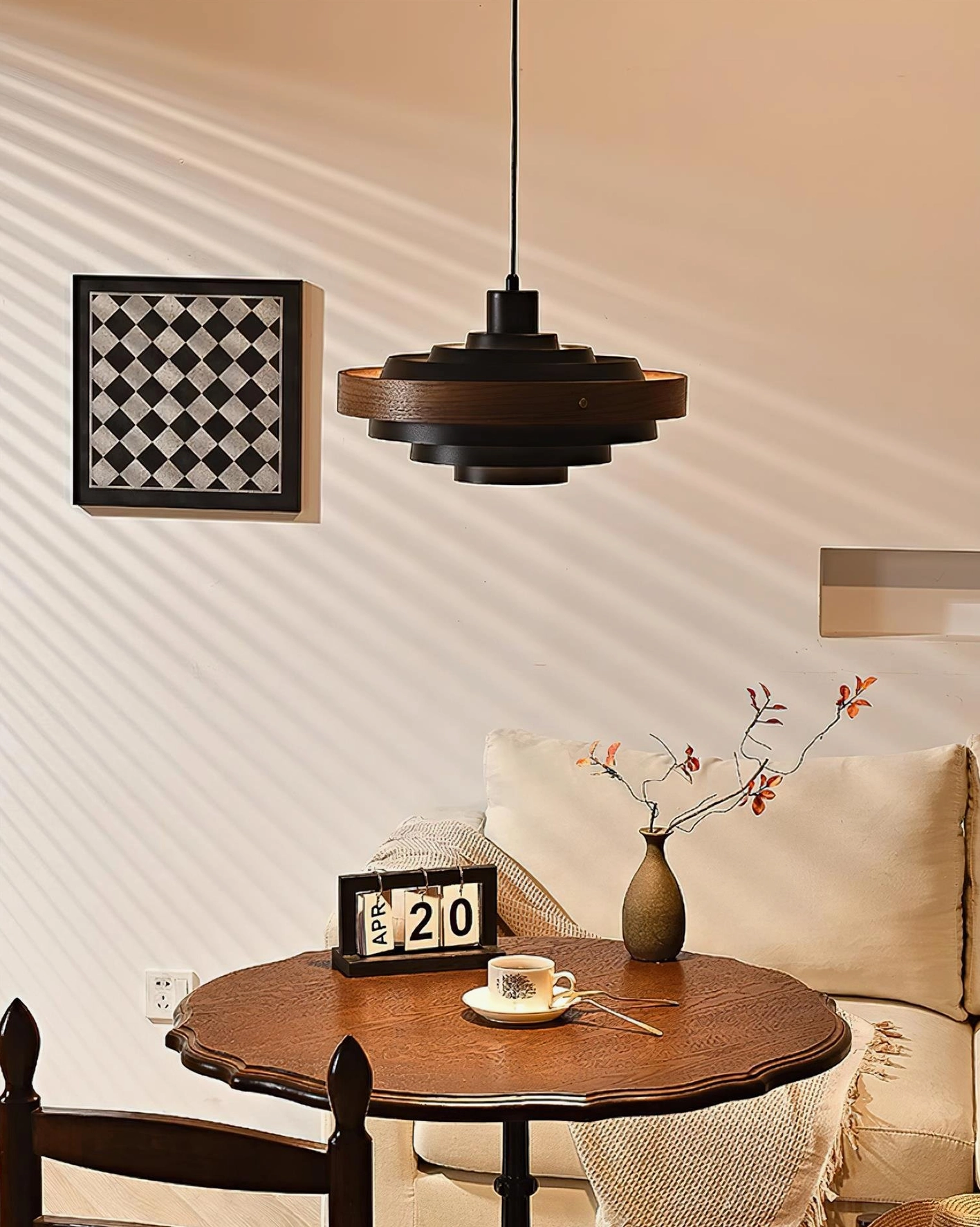 Carmen tiered pendant lamp with matte black and natural wood finish, side angle showing sculptural geometric form