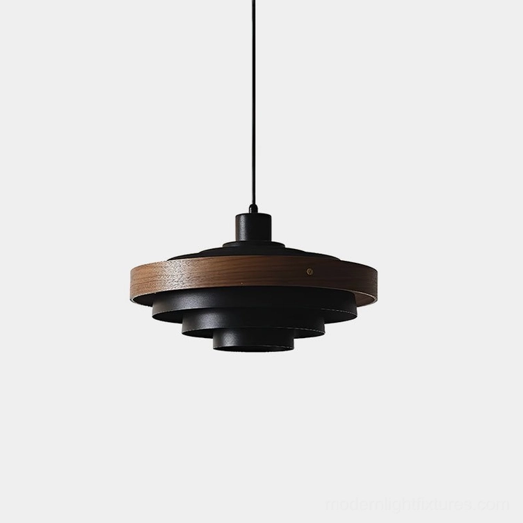 Carmen tiered pendant light in matte black and walnut wood, direct overhead view showing stacked disc construction on white background
