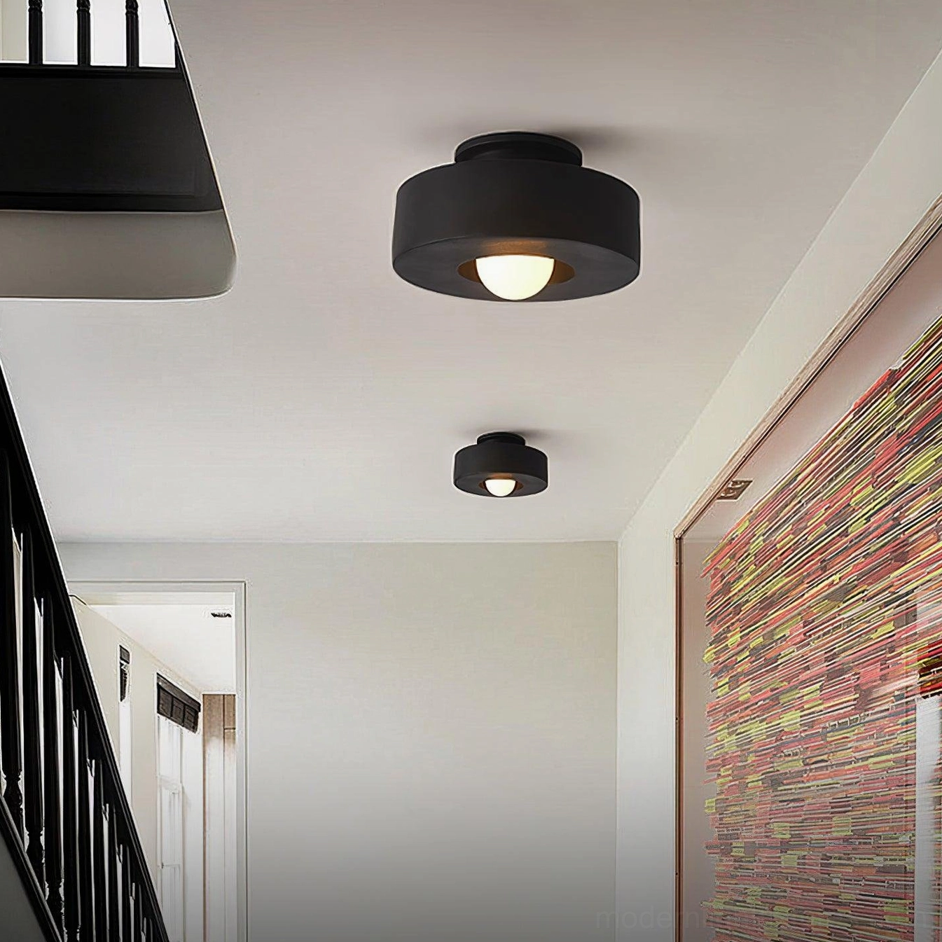Black Carneros modern flush-mount ceiling light fixtures installed in hallway stairwell, multiple units in residential space