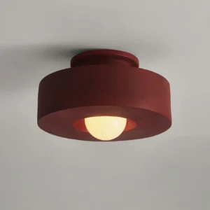 Carneros flush-mount ceiling light fixture in red, three-quarter close-up angle highlighting stacked resin geometry