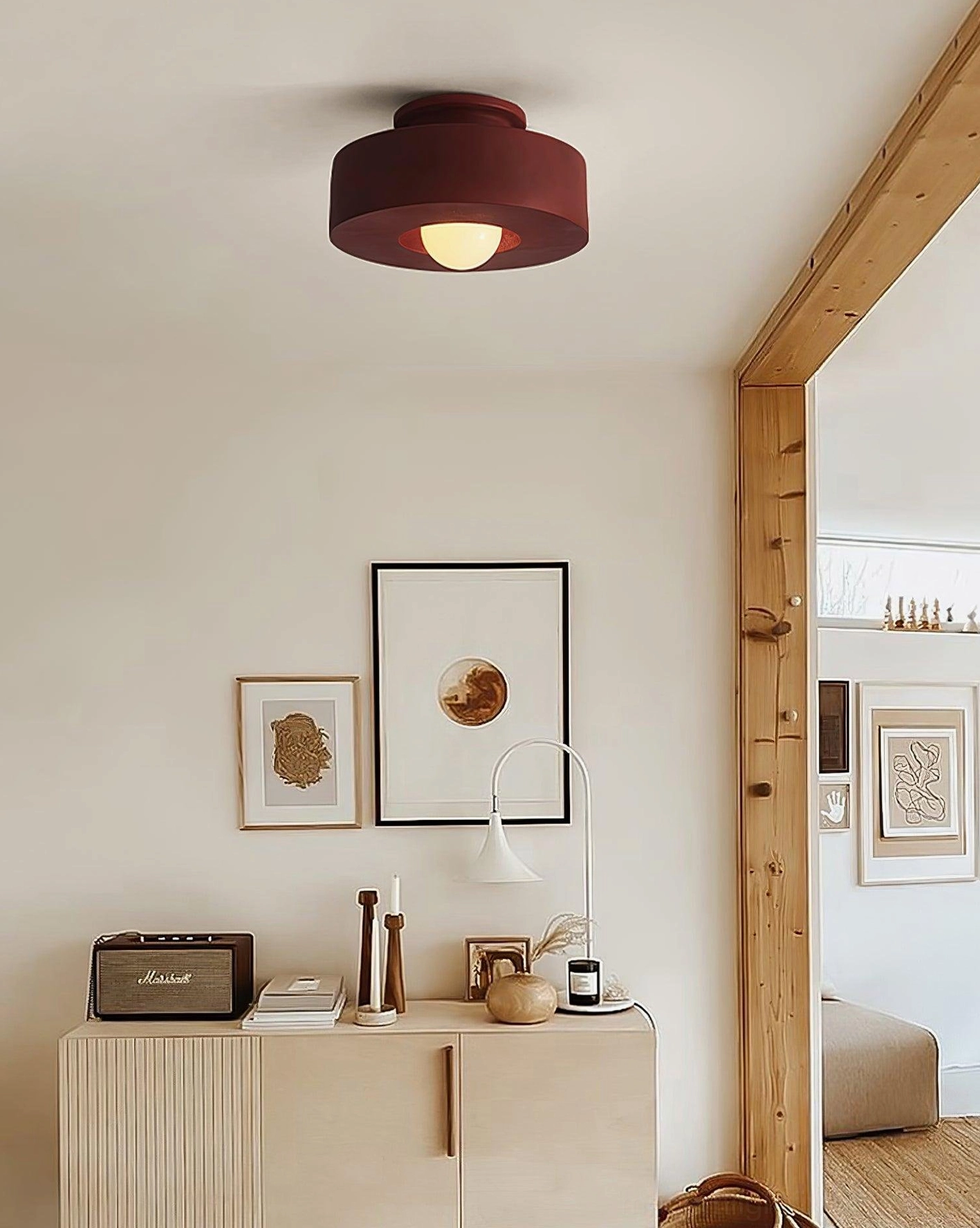 Carneros red ceiling light fixture in residential entryway with minimalist wall art and boho decor