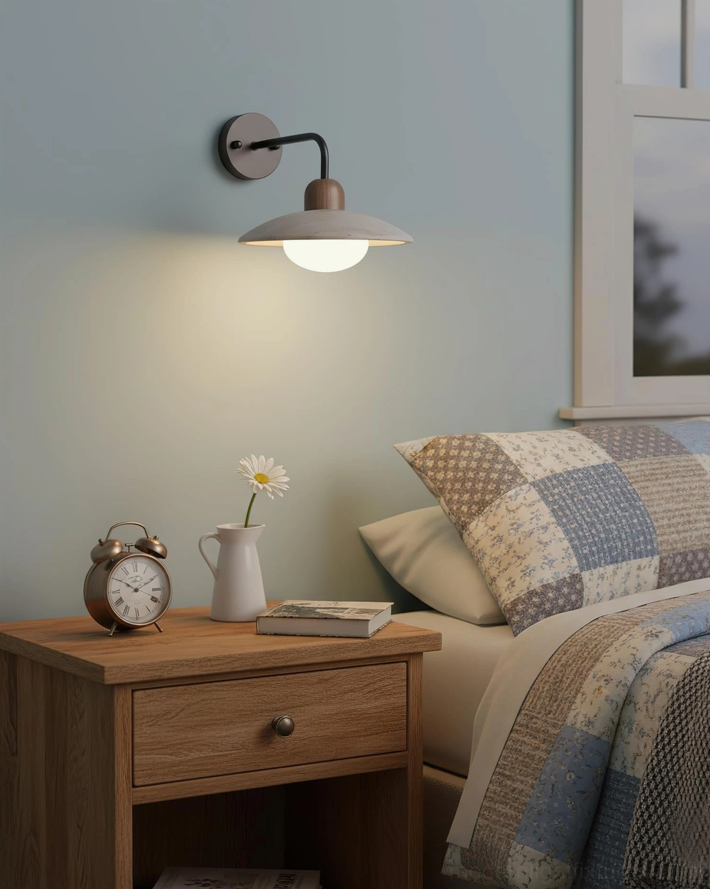Bedroom bedside wall lamp with dark metal base and compact saucer shade providing intimate reading light