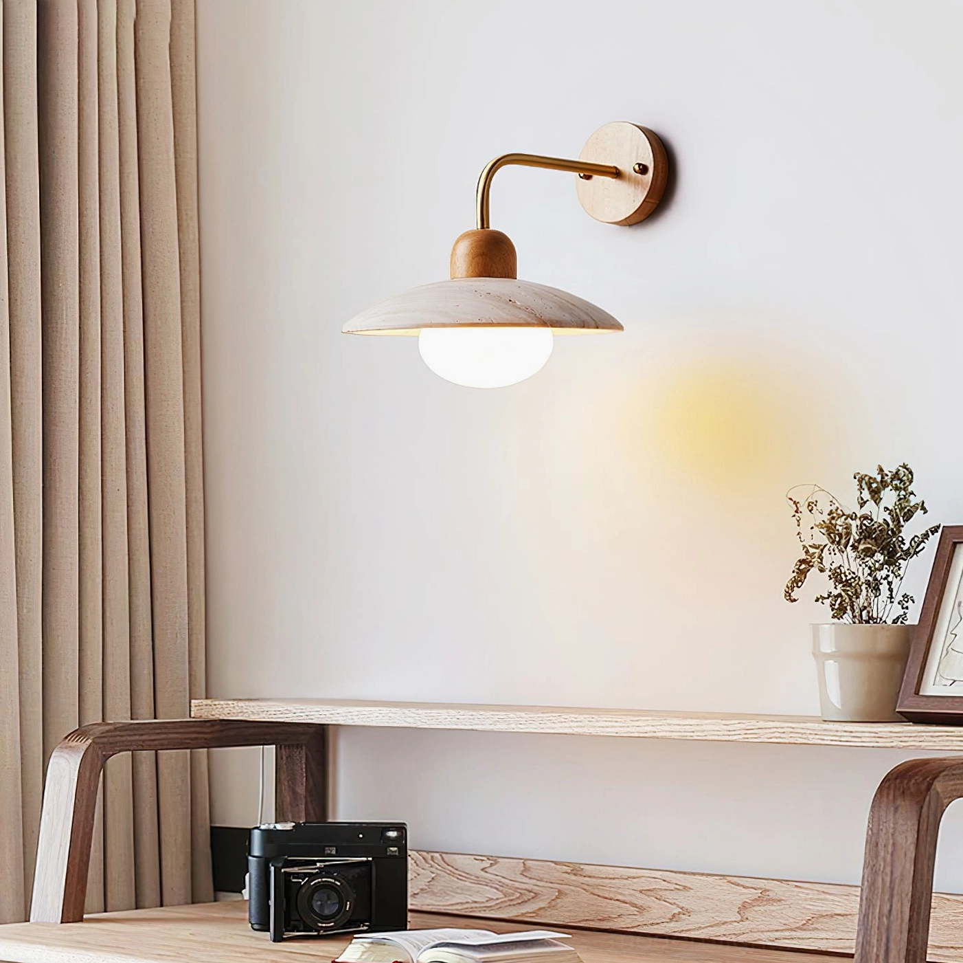 Japandi-style wall lamp with brass hardware and warm ambient lighting in home study with bench desk