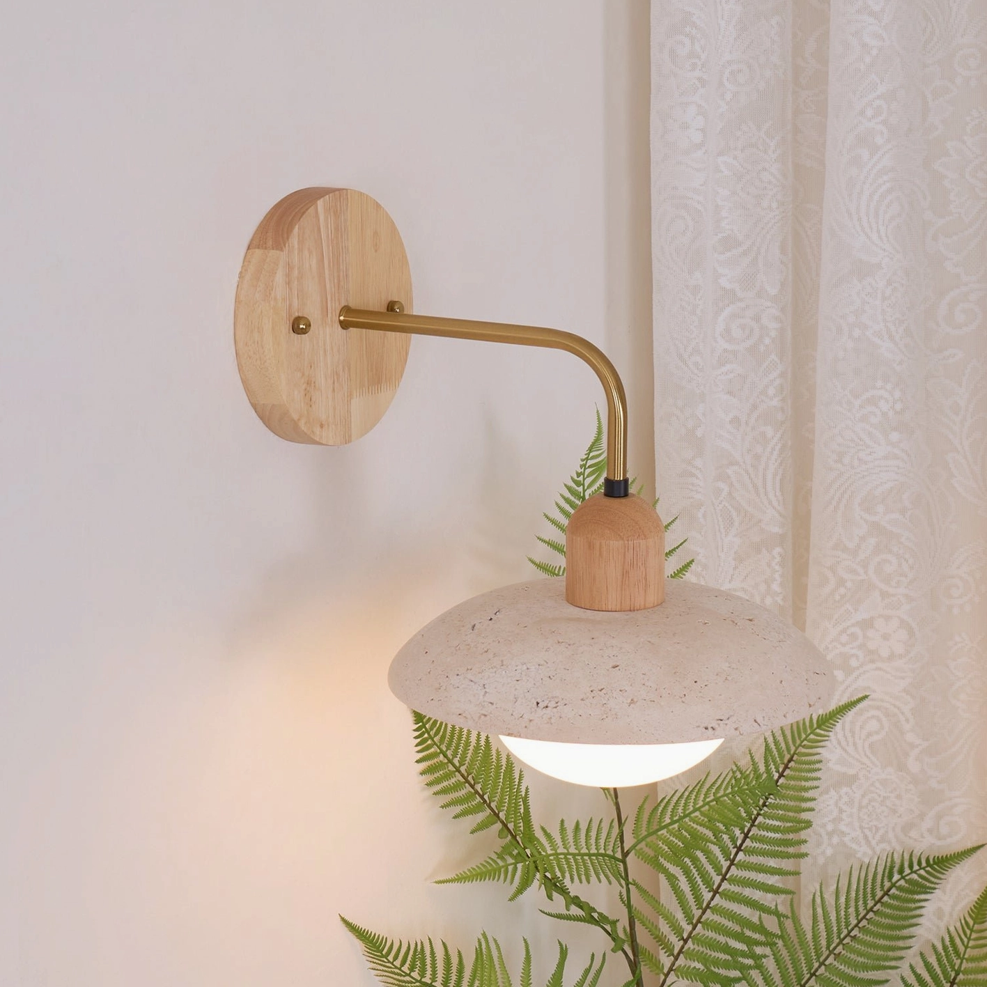 Carolia wall sconce showing natural travertine stone veining and color variation in individual shade