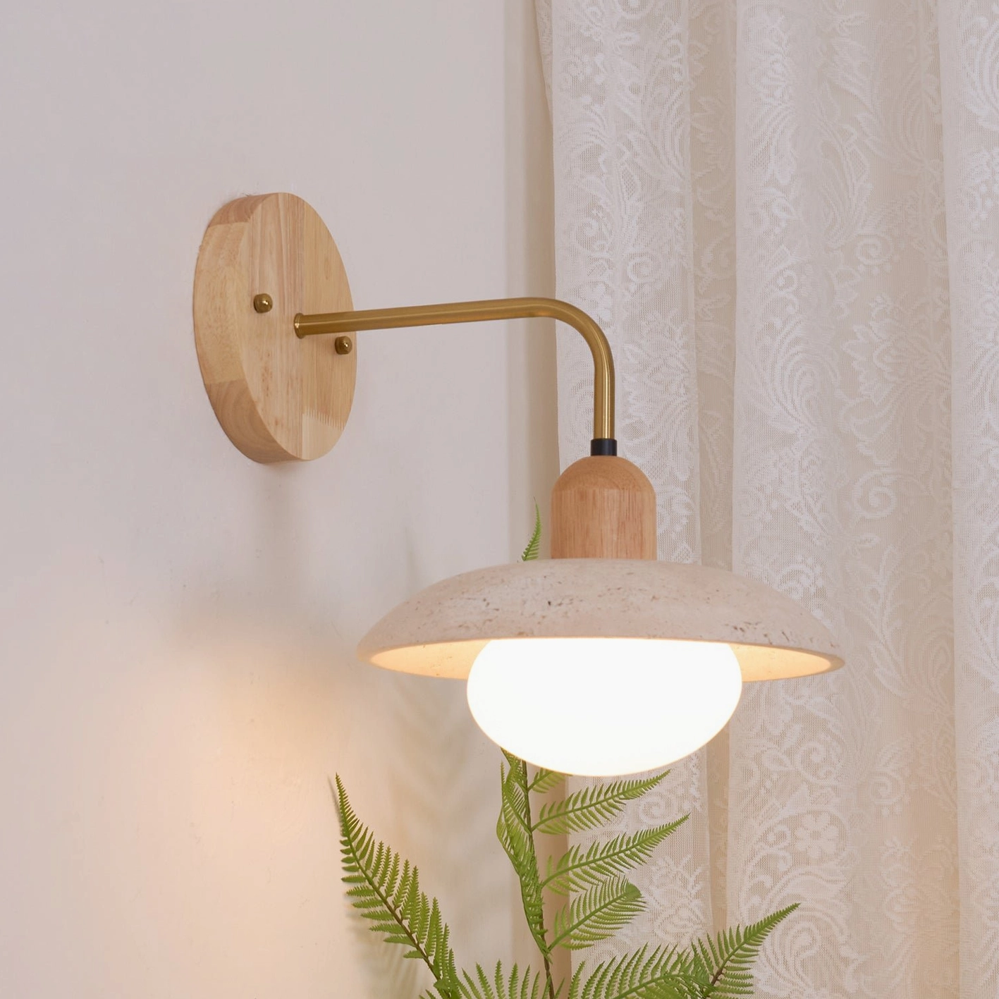 Beige wood finish Carolia wall lamp with travertine shade positioned above bedroom nightstand
