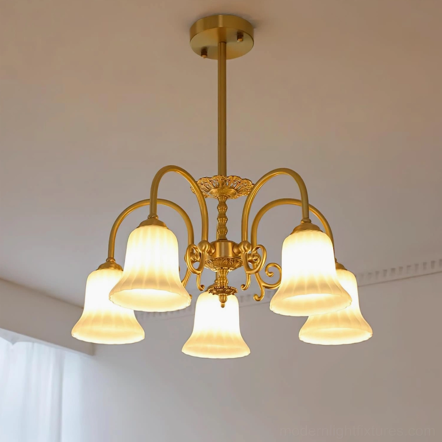 5-head brass chandelier overhead view installed in living room with sheer curtains and warm ambiance