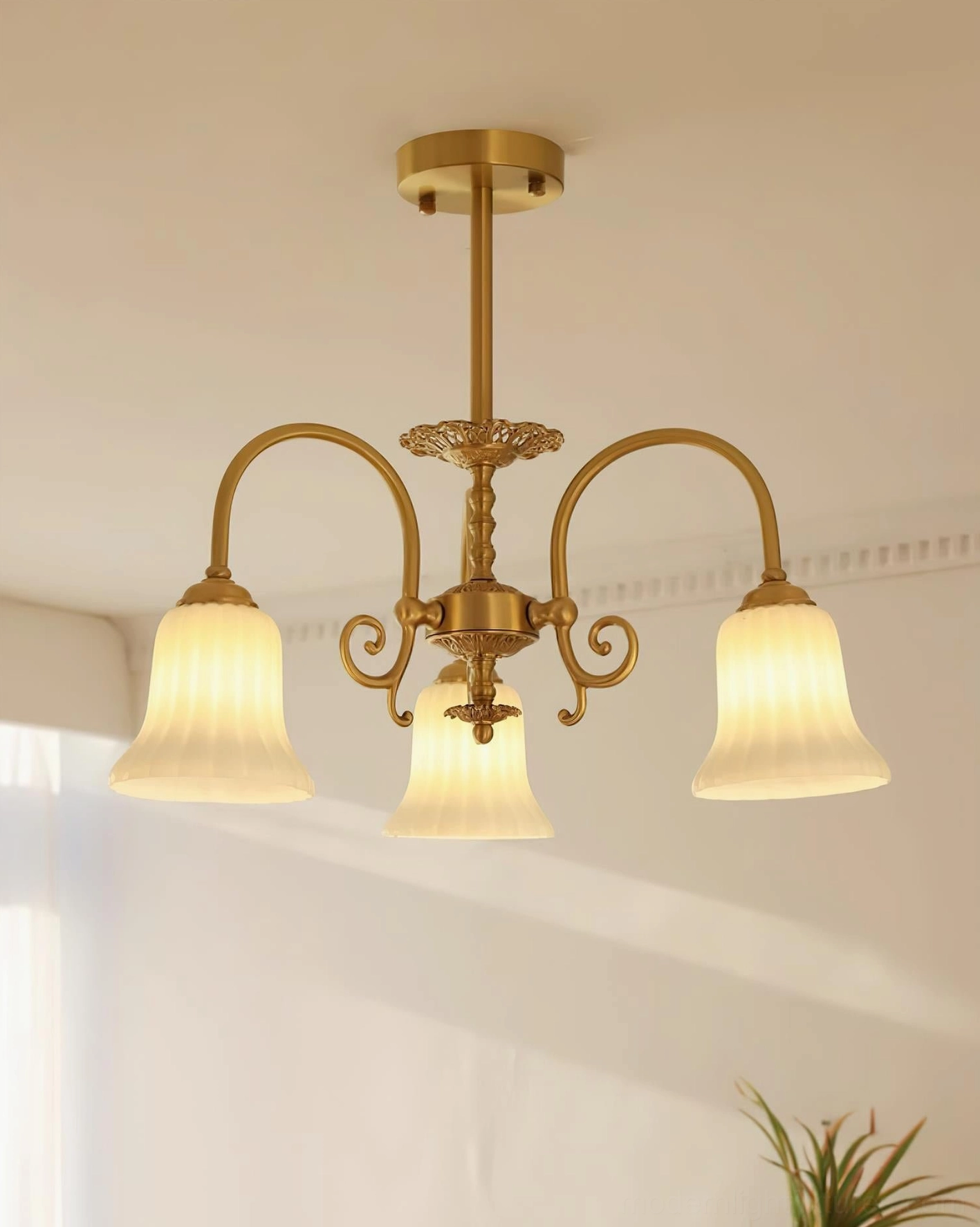 Elegant 3-head brass chandelier with ribbed glass shades installed in minimalist residential interior ceiling