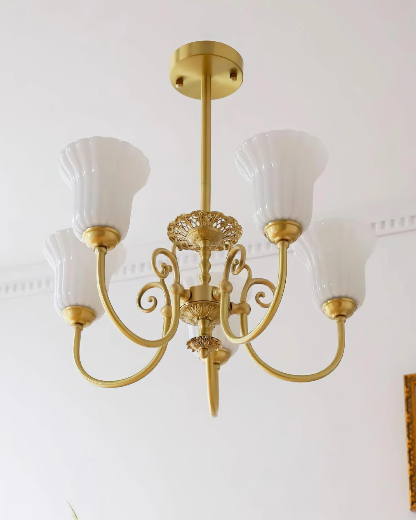 Close-up of fluted white glass shade on Caroline brass chandelier showing frosted finish