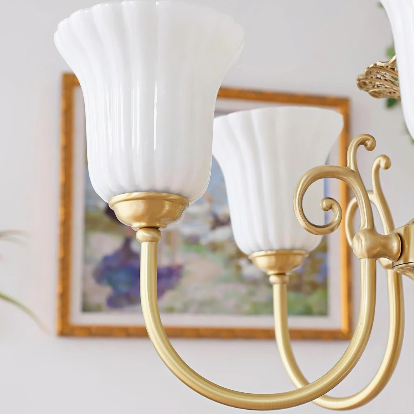 Contemporary minimalist room enhanced by classical brass chandelier with white glass shades