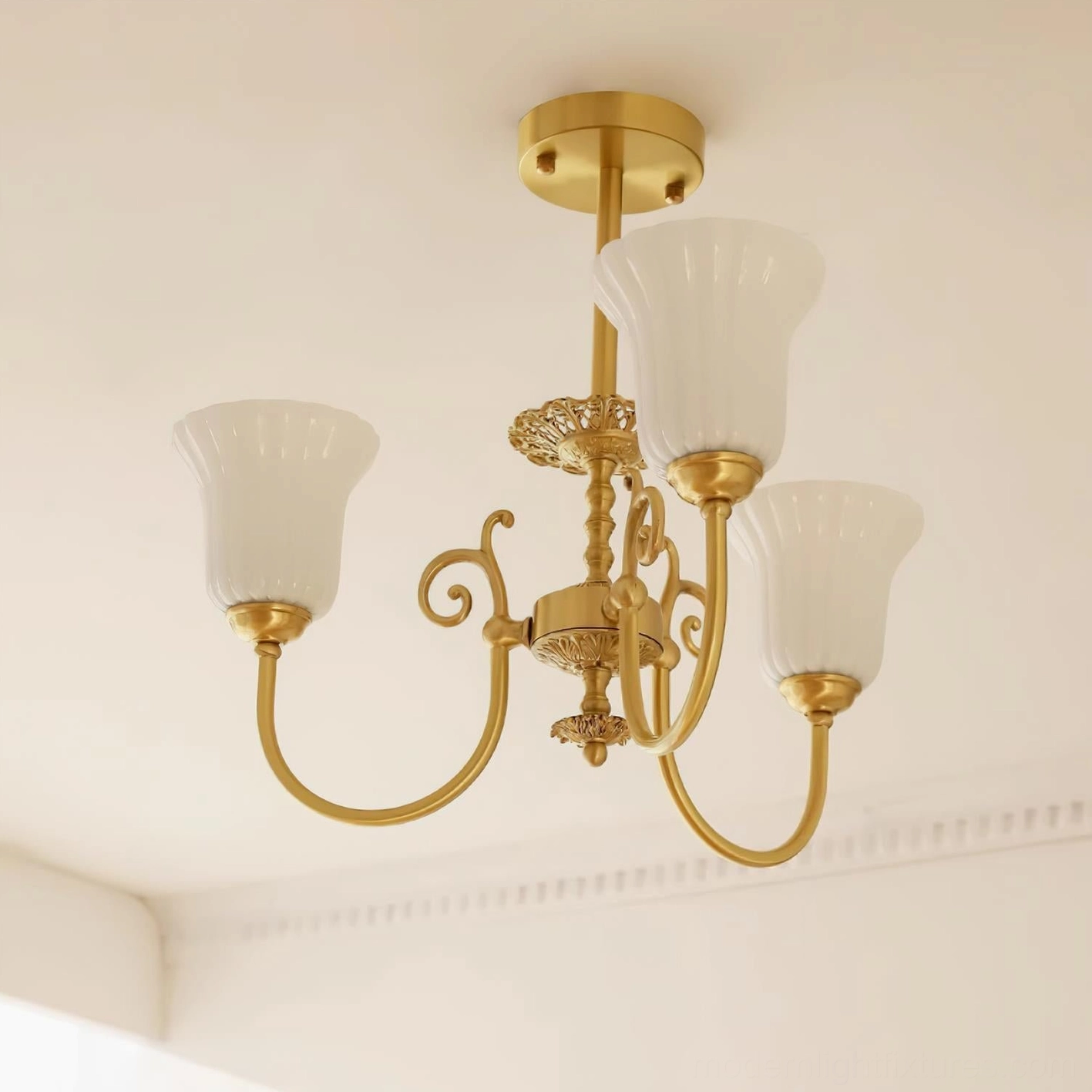 Full view of brass chandelier with white fluted shades casting warm ambient light in room