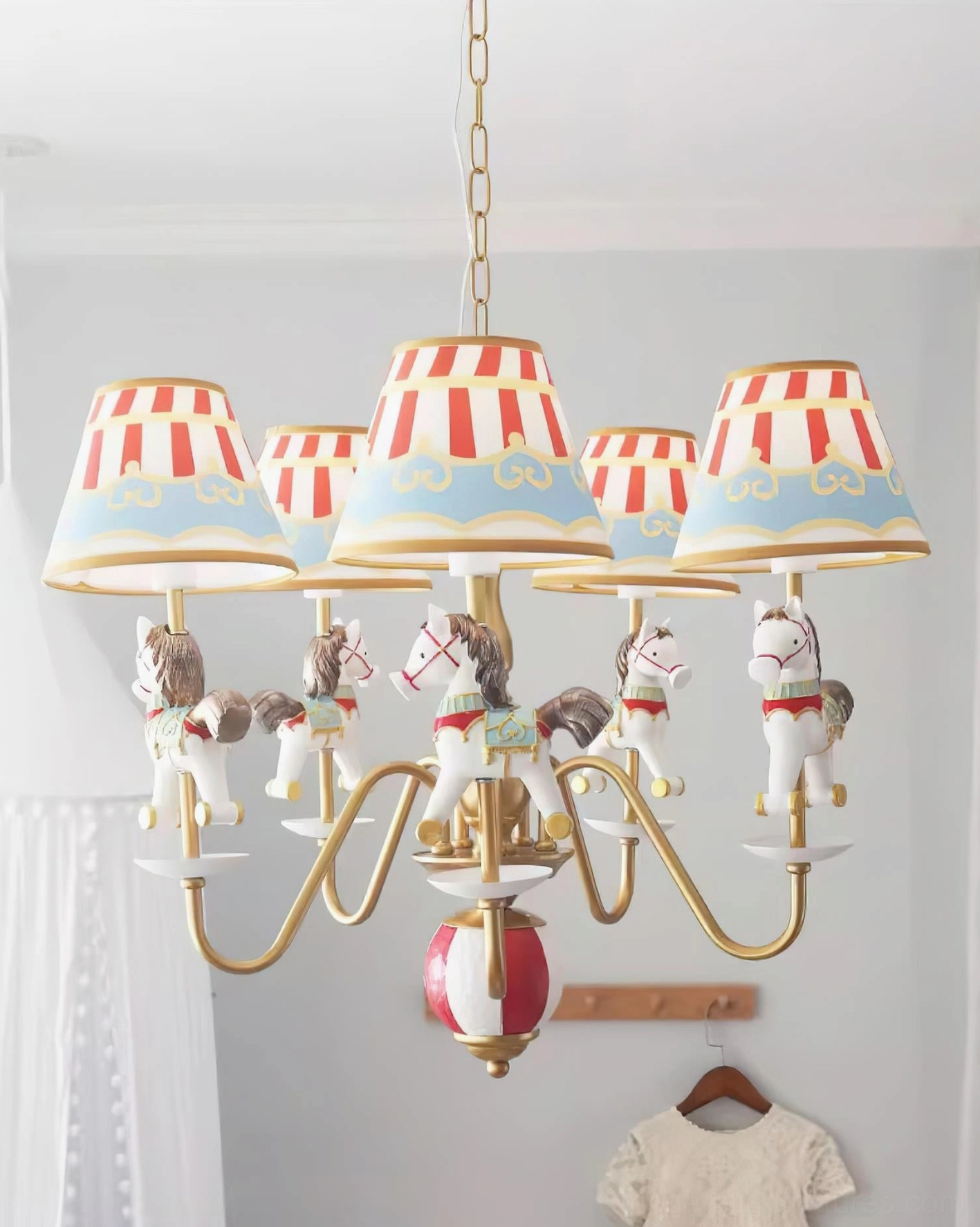 Carousel chandelier close-up showing resin animal figurines, fabric lampshade details, and decorative craftsmanship
