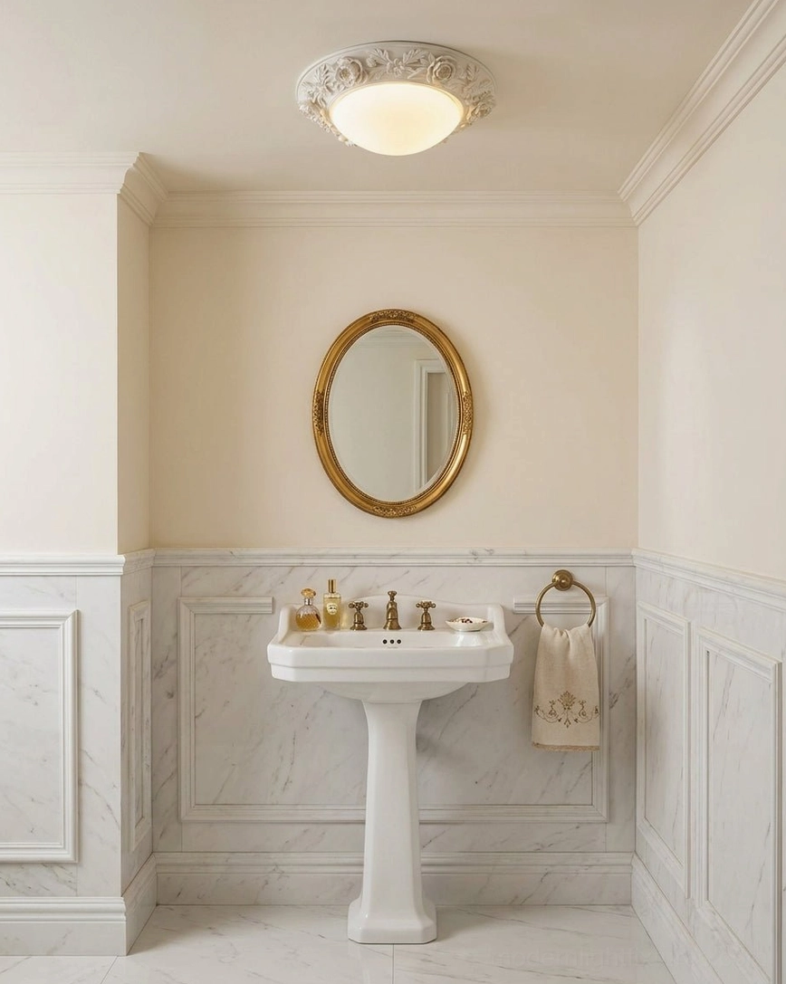 Carved floral ceiling flush light in luxury bathroom with marble wall paneling and gilded round mirror, clean aesthetic