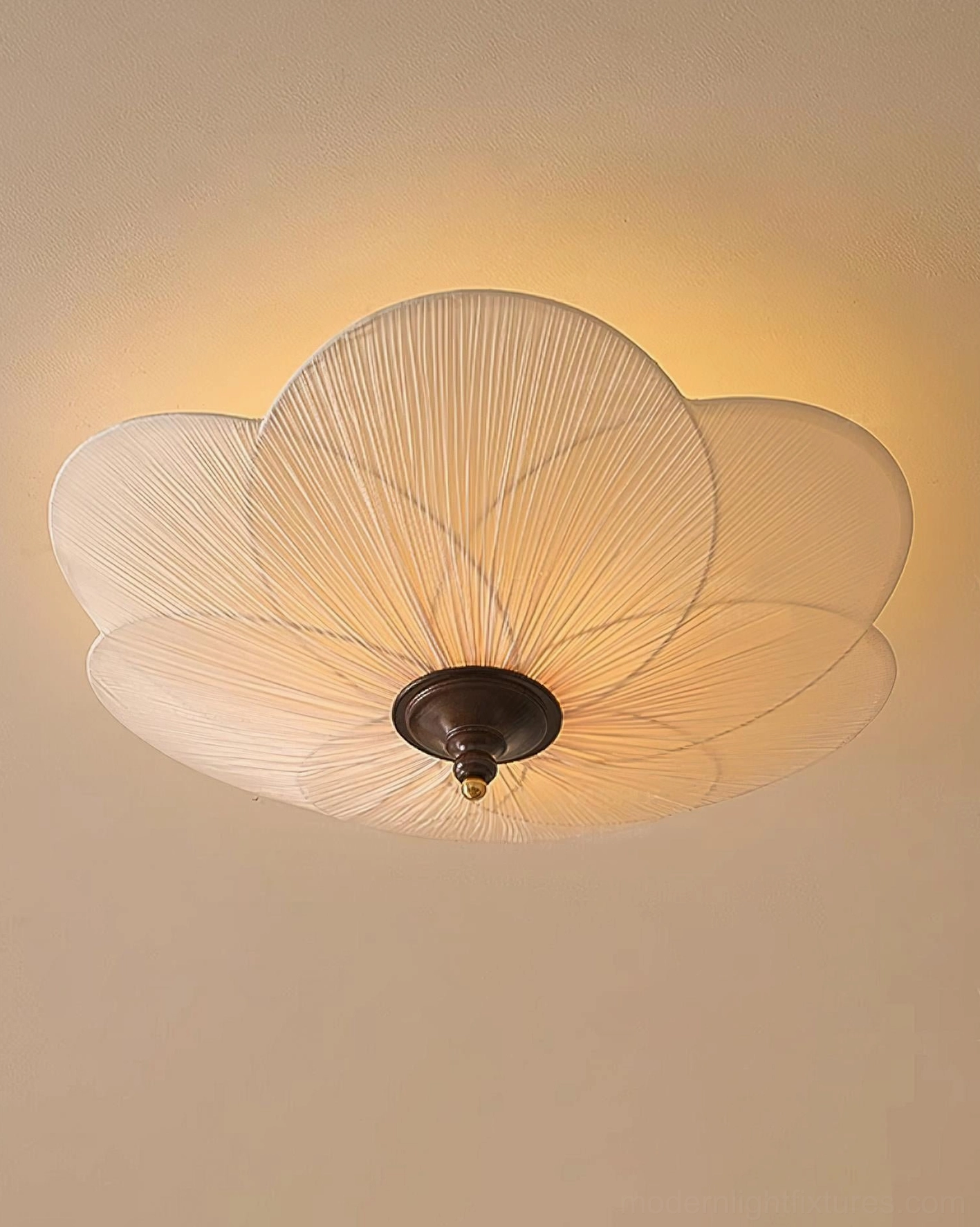 Caserta pleated petal ceiling light showing three-bulb capacity and warm diffused illumination