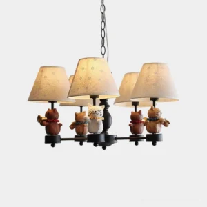 Whimsical cat and bear musician chandelier with beige fabric lampshades and black metal frame, frontal studio view