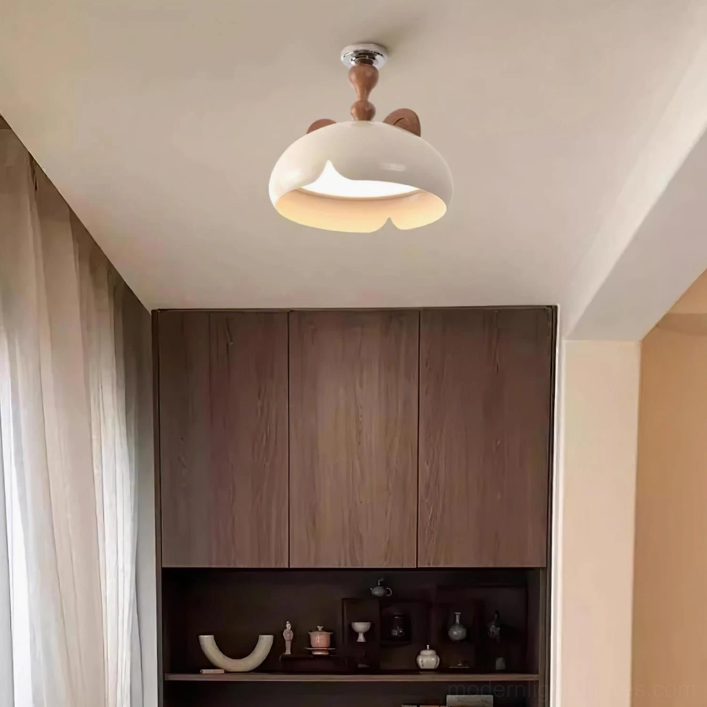 Overhead view of cat ear ceiling light fixture in master bedroom with soft diffused warm white light