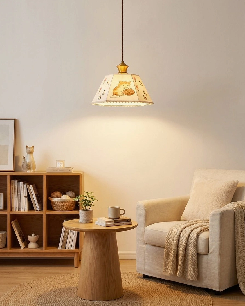 Minimalist living space with cat print pendant light, round wooden table, and modern bookshelf