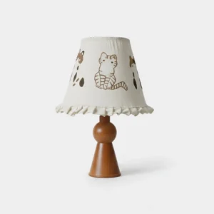 Hand-drawn cat and paw print table lamp with ruffled fabric shade and wooden base front view
