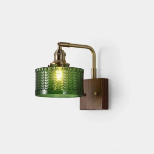 Cavella green glass fish-scale wall sconce with antique brass and walnut wood base, front studio view