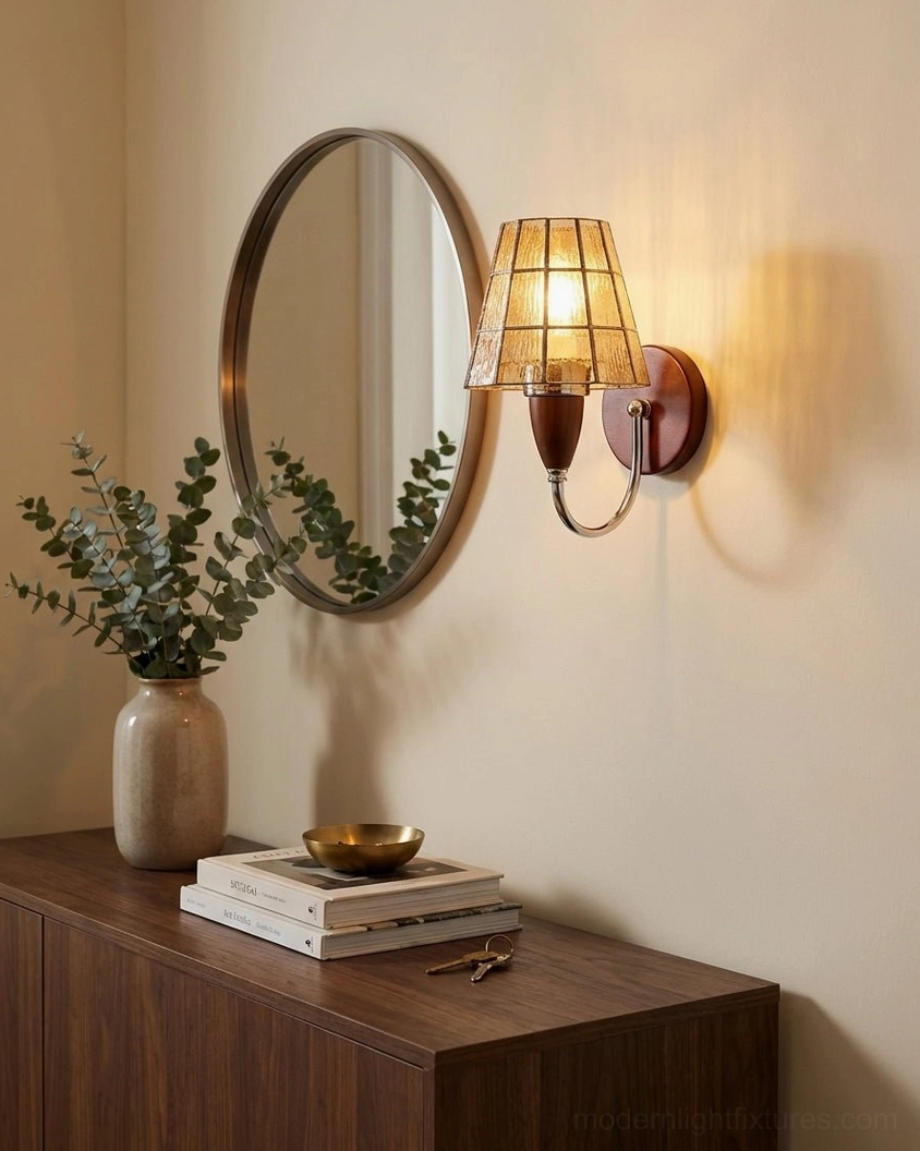 Cavero sconce with amber stained glass shade mounted above vanity with eucalyptus plant and warm wood furniture