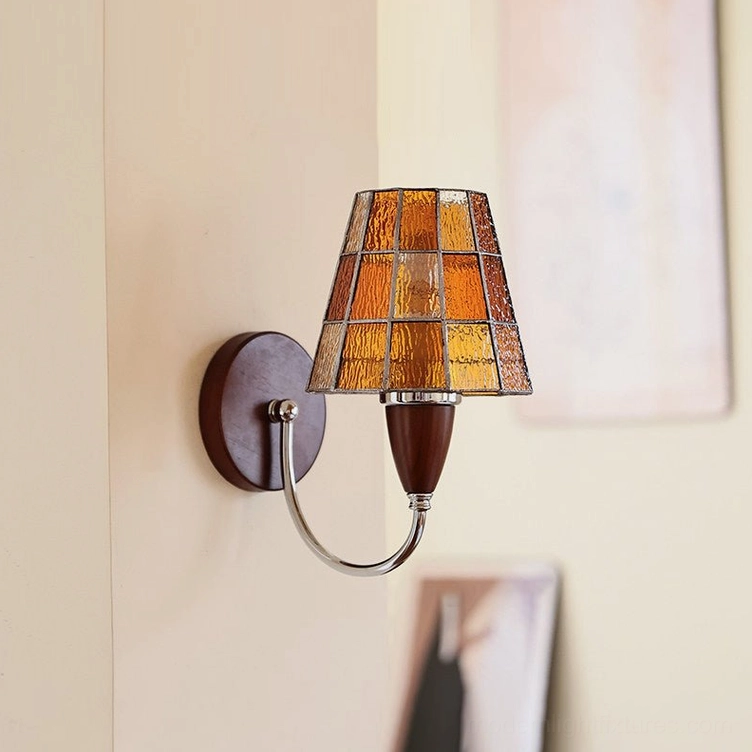Cavero wall sconce with amber stained glass shade creating warm atmospheric lighting in residential interior