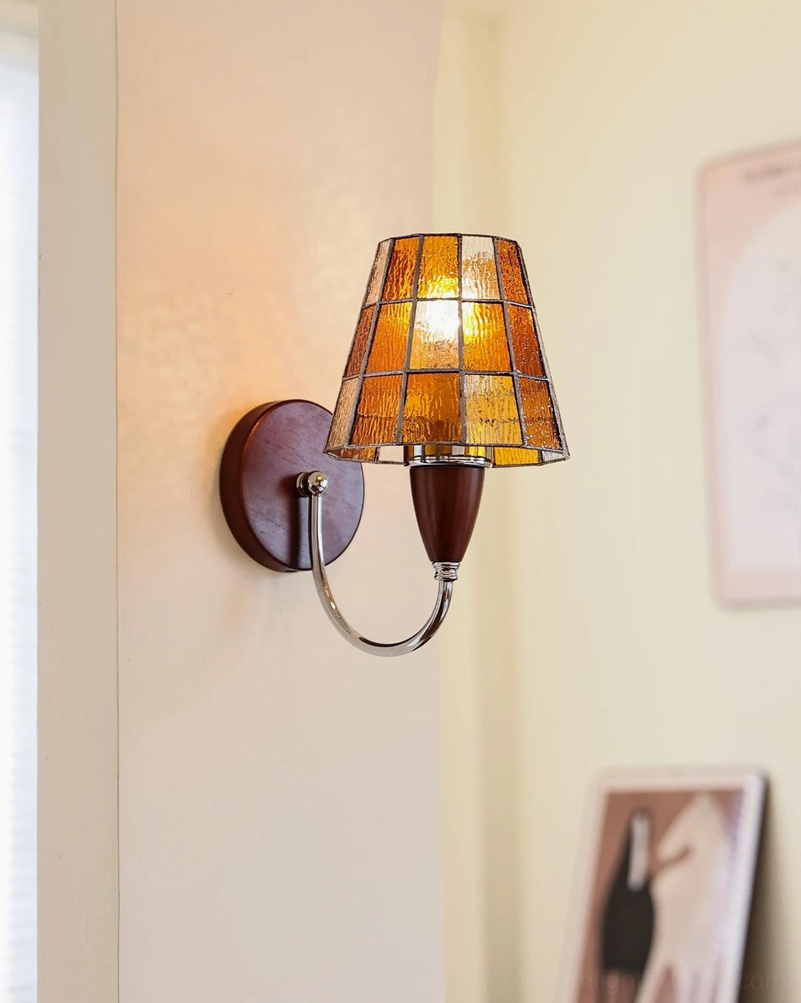 Cavero wall sconce full view showcasing curved metal arm and decorative stained glass shade in multiple finishes