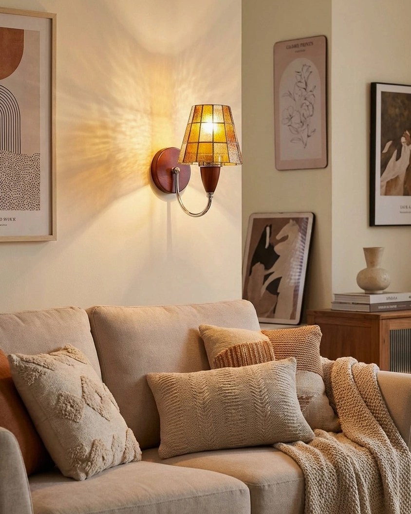 Cavero wall sconce mounted in living room above sofa with warm textured glass providing accent wall lighting