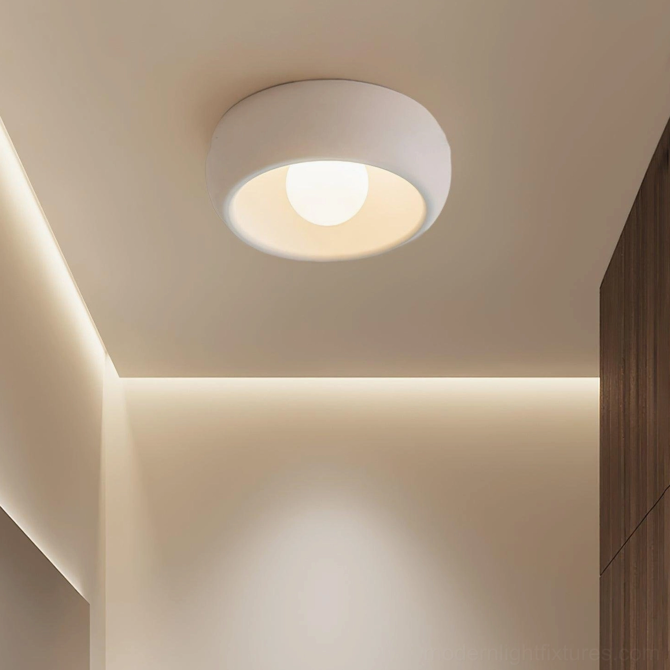 Flush ceiling light with warm light quality in bedroom with cove lighting accent, showing damp rated fixture performance