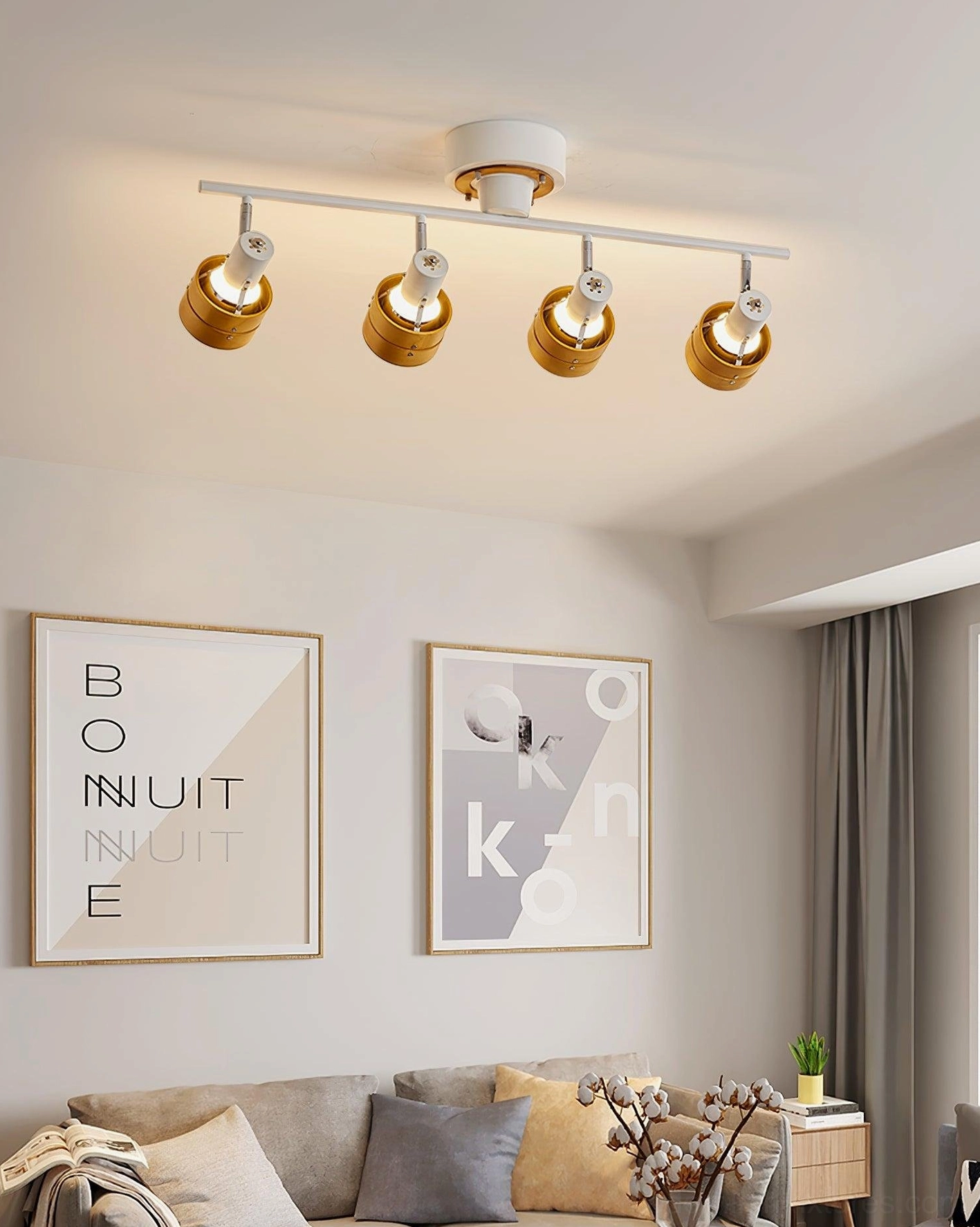 Four-head adjustable track lighting fixture mounted on ceiling with directional beam angles