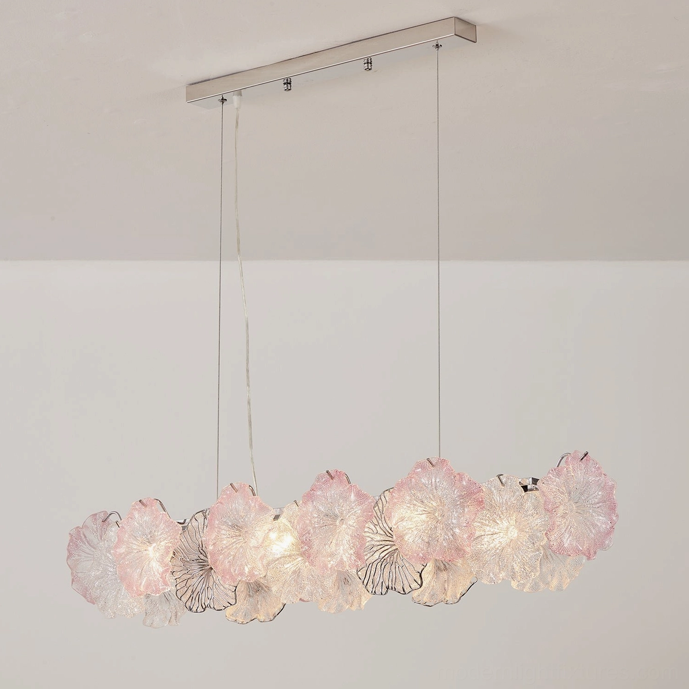 Celadine hand-formed glass flower chandelier assembly showing chrome frame, cable suspension, and petal arrangement detail