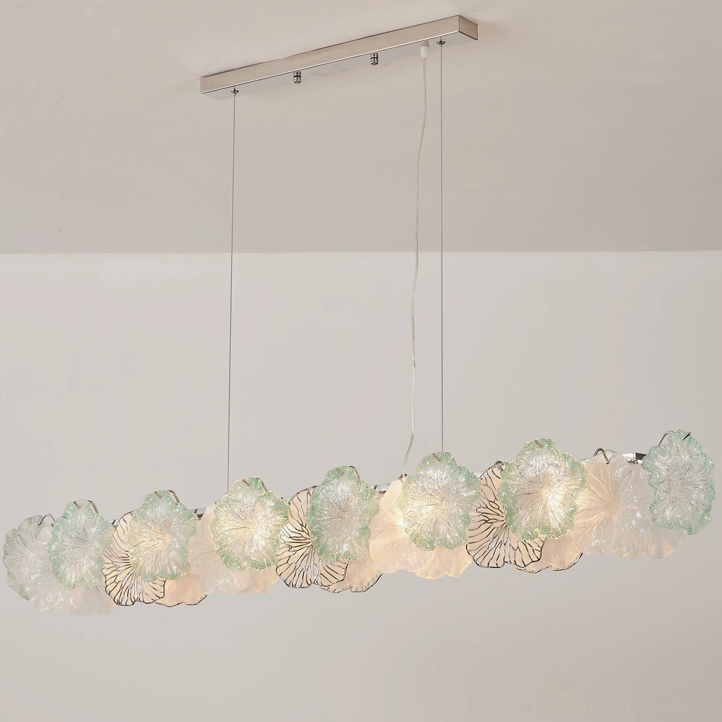 Celadine linear glass flower chandelier showing translucent quality of hand-formed petals with mixed tinted and clear glass