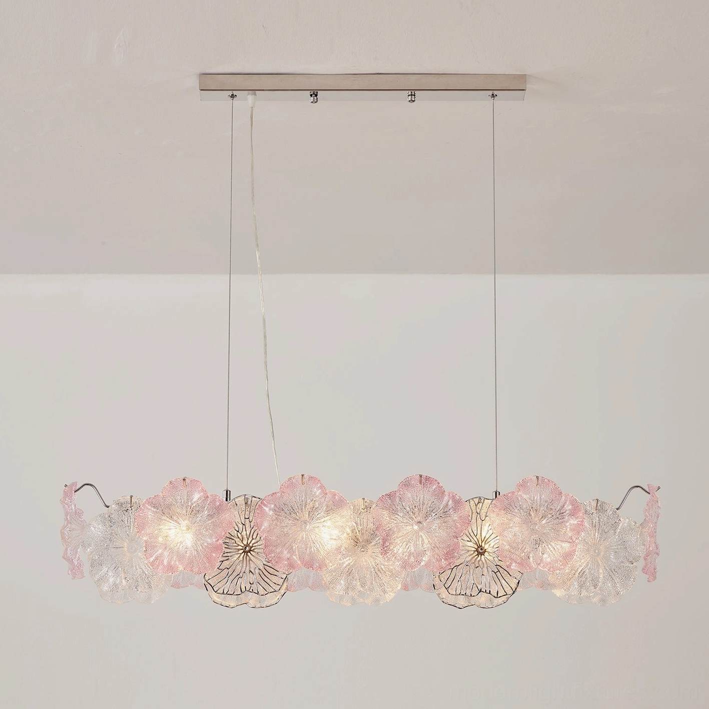 Celadine round chandelier in seafoam green with hand-formed textured glass blossoms, side angle showing dimensional petal structure
