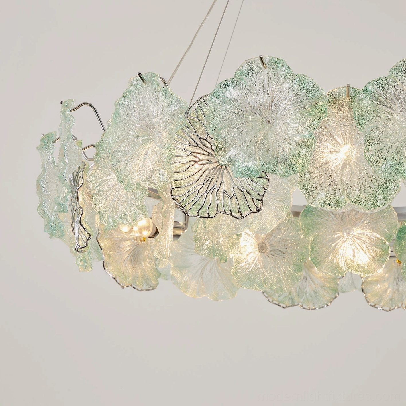 Celadine hand-formed glass flower chandelier with seafoam green and clear petals, polished chrome hardware detail