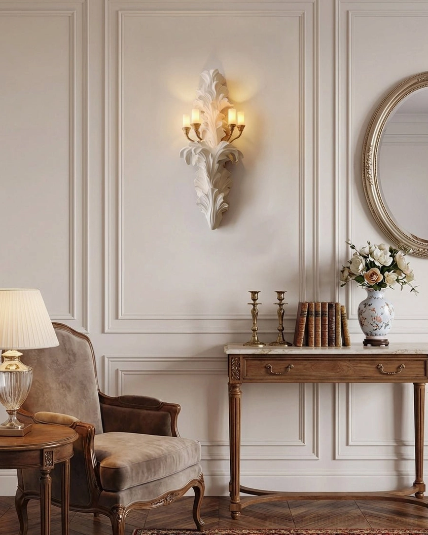 Celandra botanical wall sconce on paneled wall with round mirror and wooden console, traditional refined classical interior design setting