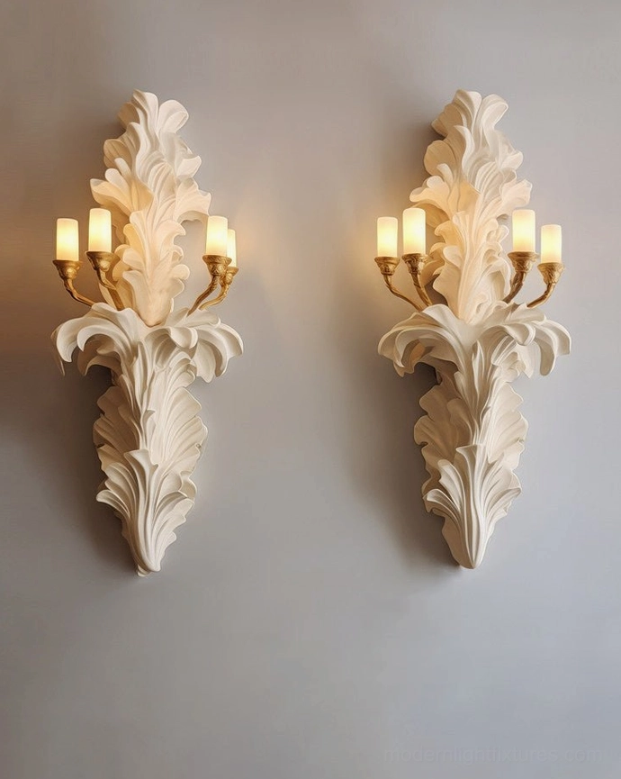 Pair of matching Celandra botanical wall sconces with acanthus leaves, brass lamp holders, and candle-style bulbs, displayed side-by-side on gray wall